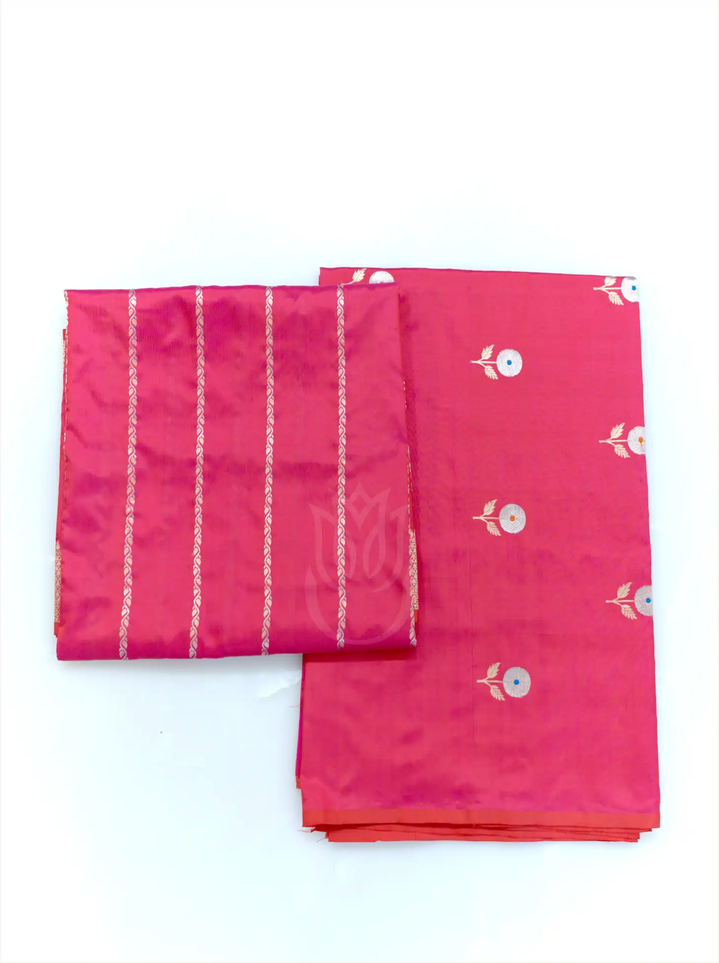 Folded magenta pink handwoven Banarasi silk suit fabric featuring silver floral bootis next to a matching tissue zari striped dupatta against a clean white background.