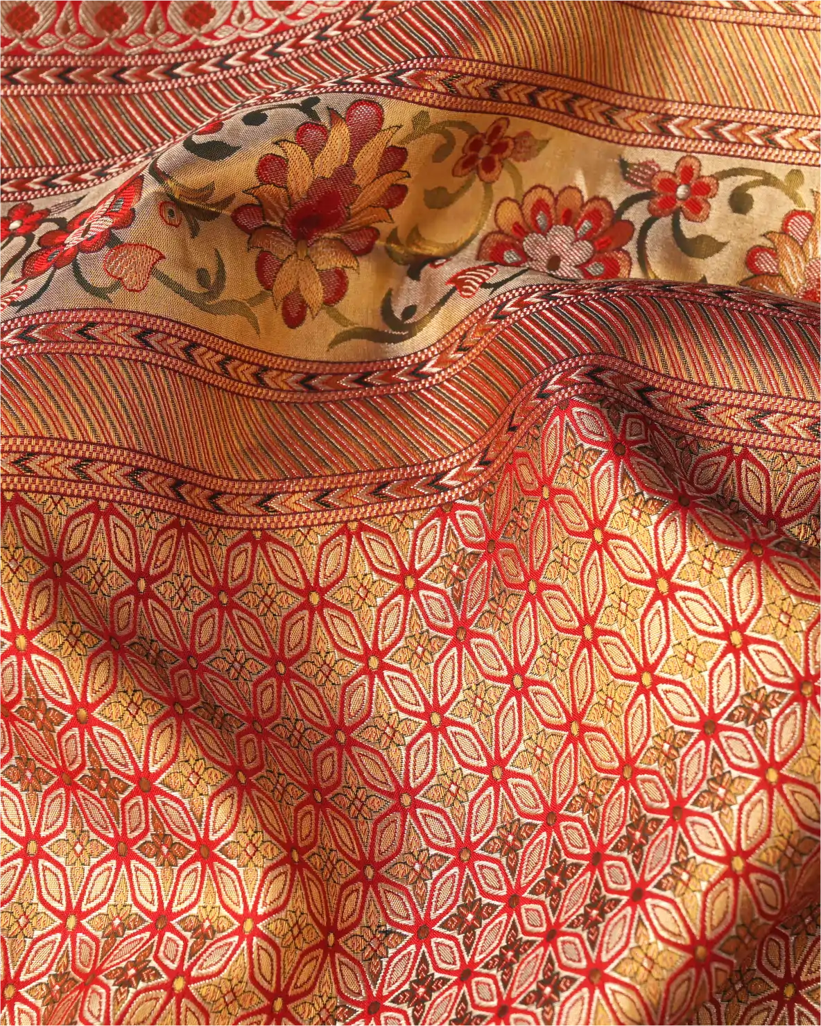 Model wearing a handwoven champagne gold and coral orange Rangkart Kanchipuram pure silk saree with an intricate gold zari border and pallu.