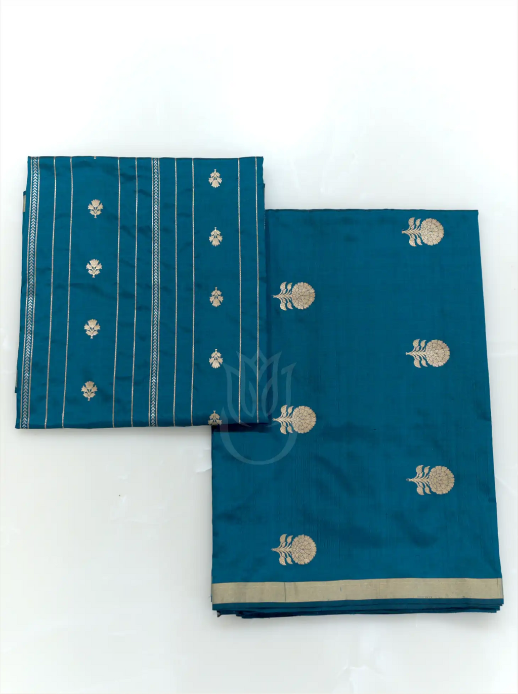 Folded teal blue handwoven Chinia silk suit fabric featuring gold zari floral bootis next to a matching striped zari dupatta against a clean white background.