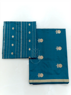 Folded teal blue handwoven Chinia silk suit fabric featuring gold zari floral bootis next to a matching striped zari dupatta against a clean white background.
