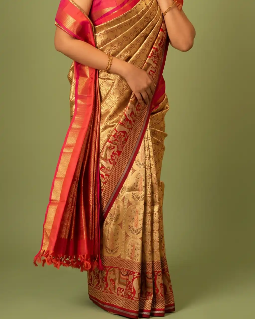 Model wearing a handwoven gold and red Kanchipuram pure silk saree featuring woven motifs and a rich red zari border with tassels.