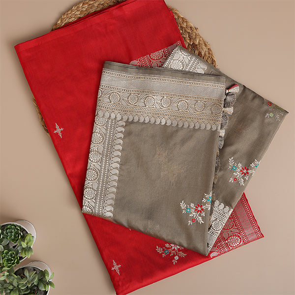 Detailed close-up of the Crimson Radiance handwoven Katan silk fabric highlighting the luxury texture and intricate traditional golden border weave.