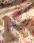 Close-up shot of handwoven pink tissue Patola Kanjivaram silk saree featuring intricate pink floral and peacock motifs woven with zari detailing.
