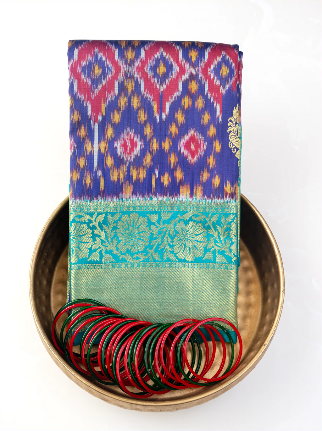 Close-up view of the pallu and border on a handwoven purple and green Patola Kanjivaram silk saree.