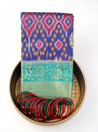 Close-up view of the pallu and border on a handwoven purple and green Patola Kanjivaram silk saree.