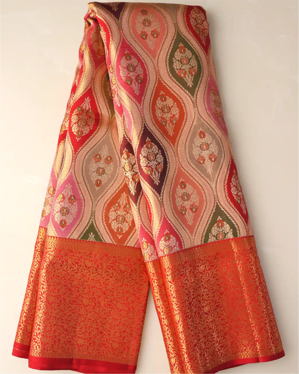 Full vertical drape of a handwoven multicoloured Rangkart Kanchipuram silk saree with intricate floral motifs and a rich red gold zari border.