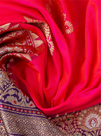 Close-up of draped red pure Katan silk saree showcasing metallic gold zari floral motifs and detailed purple and gold zari border.
