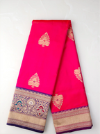 Folded handwoven red pure Katan silk saree showcasing gold zari floral motifs and a rich ornate gold zari border.