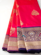 Close-up view of a gold zari mango kalka motif woven into a handwoven red pure Katan silk saree.