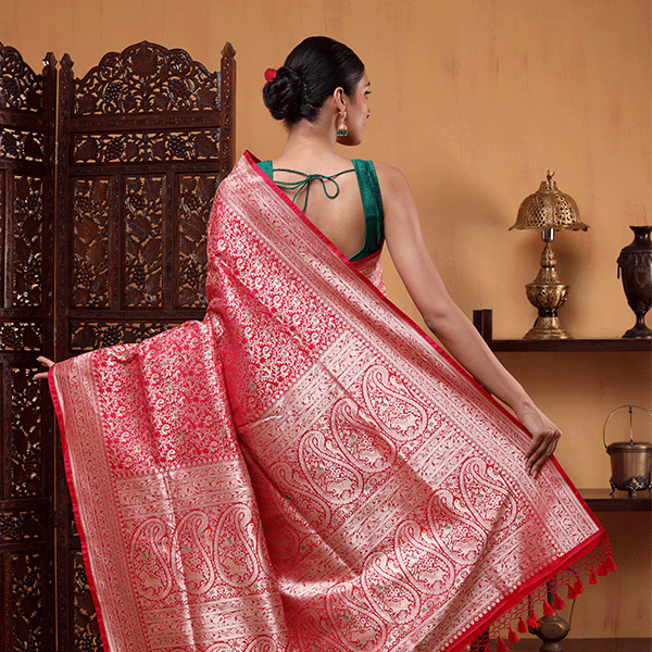 Close-up detail of the authentic handwoven Shikargah pattern and intricate gold zari jaal on premium crimson red Katan silk fabric.