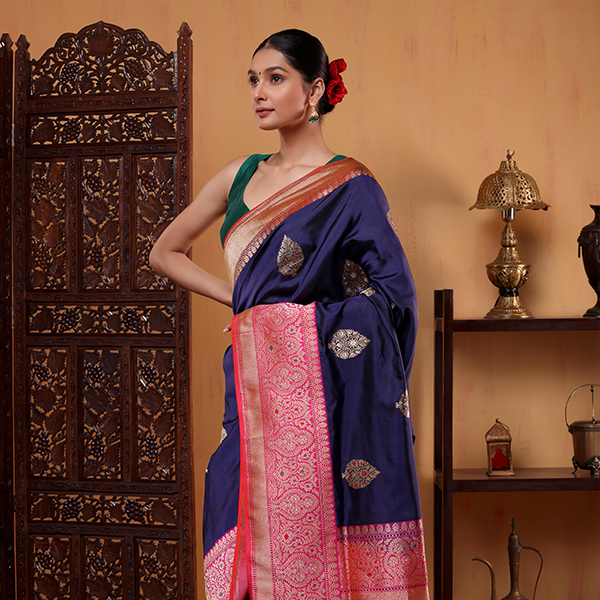 Side profile view of the handwoven Indigo Enigma Katan silk saree, showcasing the full four-sided border and elegant drape flow.