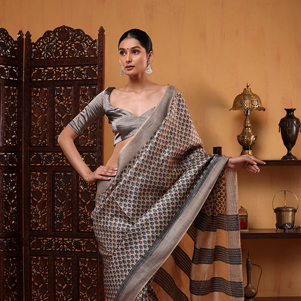 Side profile view of the handwoven Ivory Elegance Tussar silk saree showcasing the full length drape flow and elegant zari border.