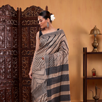 Side profile display of the handwoven natural ivory Tussar silk saree showcasing the full length drape and border design.