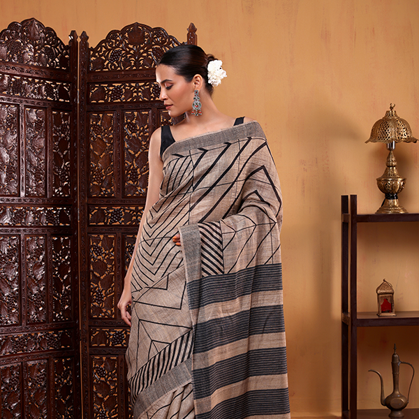 Side profile display of the handwoven natural ivory Tussar silk saree showcasing the full length drape and border design.