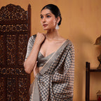 Close-up shot of the natural organic texture and detailed handloom boota embroidery work on the pure Tussar silk saree fabric.