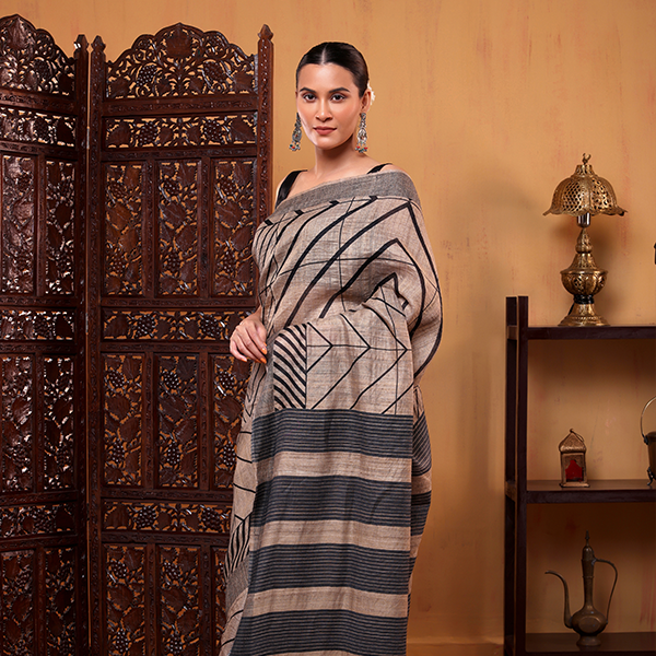 Close-up view of the natural organic texture and elegant geometric stripe details on the pure Tussar silk fabric.
