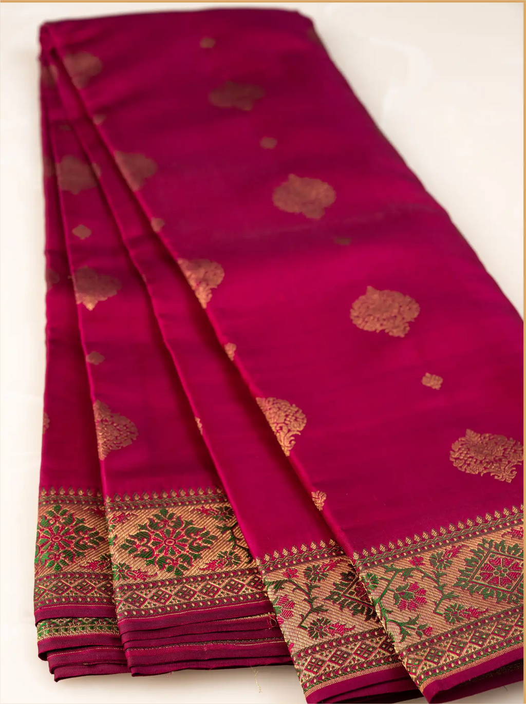 Detailed close-up of a handwoven Kanjivaram Paithani silk saree showcasing the heavy woven gold zari border, traditional temple design edges, and glossy silk texture.