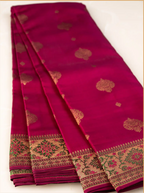 Detailed close-up of a handwoven Kanjivaram Paithani silk saree showcasing the heavy woven gold zari border, traditional temple design edges, and glossy silk texture.