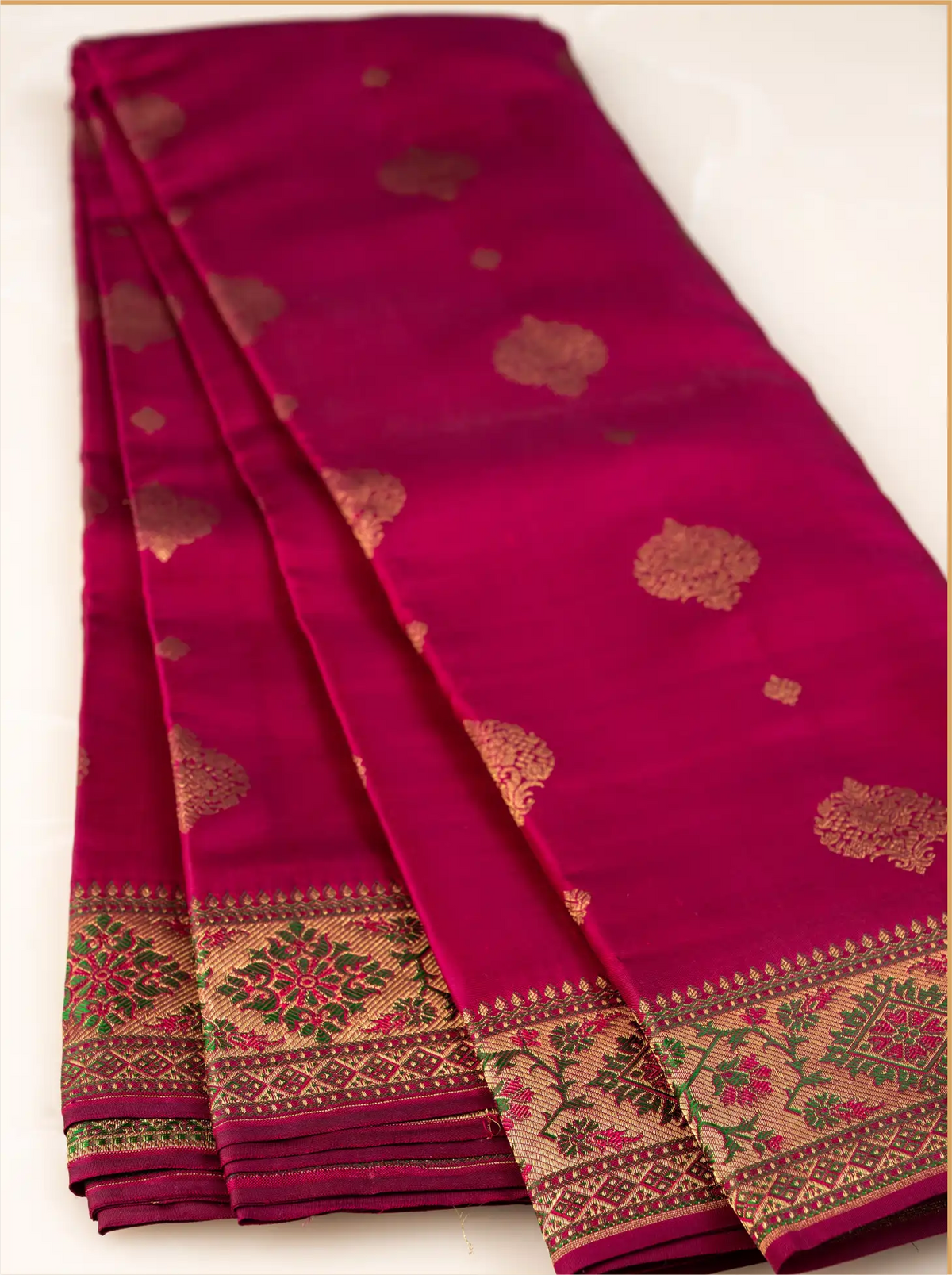 Detailed close-up of a handwoven Kanjivaram Paithani silk saree showcasing the heavy woven gold zari border, traditional temple design edges, and glossy silk texture.
