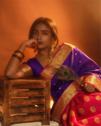 Detailed view of the traditional contrast border on the purple handwoven silk saree.