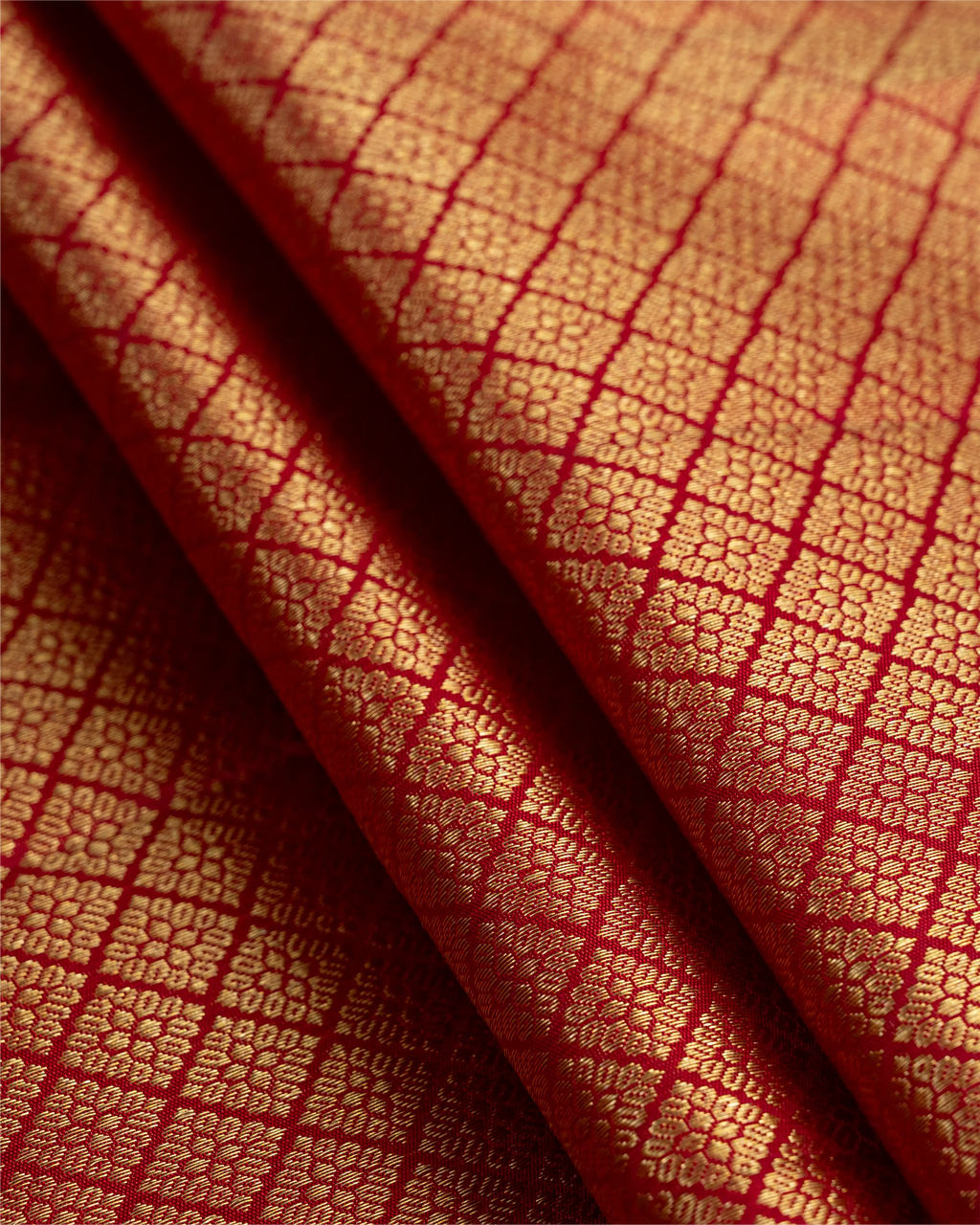 Stylized shot of the Kanjivaram silk saree, ideal for bridal or festive occasions.