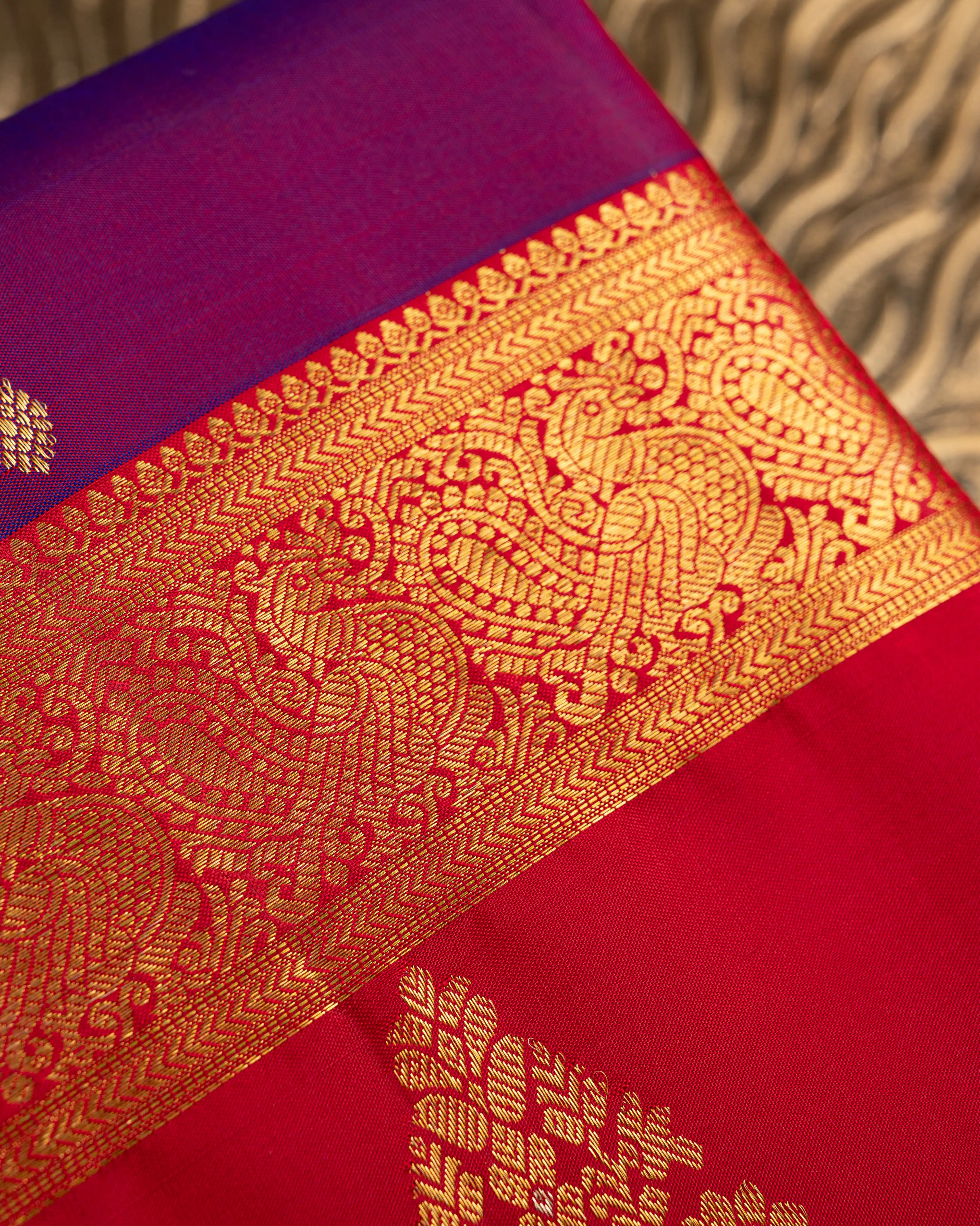 Close-up of the premium handwoven Kanjivaram silk fabric texture and zari weave.