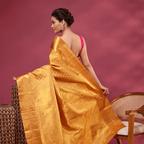 The handwoven self jaal unstitched blouse material with an intricate border, matching the golden mustard Kanjivaram saree.