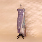 A mannequin displaying a lavender Banarasi silk suit paired with a vibrant multicolored digital Kalamkari dupatta.