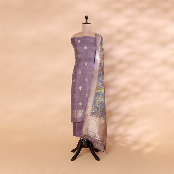 A mannequin displaying a lavender Banarasi silk suit paired with a vibrant multicolored digital Kalamkari dupatta.
