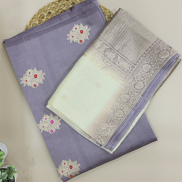 Close-up view of the premium light blue pure Banarasi Silk dress material, showcasing the detailed traditional handloom weave, metallic Zari patterns, and fine Meena work.