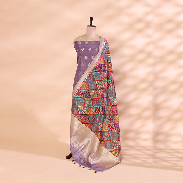 A mannequin displaying an elegant light purple handwoven silk suit, paired with a vibrant, multicolored traditional dupatta featuring intricate patterns and a delicate zari border.