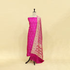 Vibrant magenta pure Banarasi silk suit paired with a fiery sunset red and gold Bandhani dupatta, displayed elegantly on a mannequin.