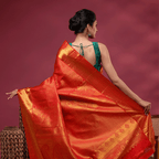 Close-up detail of the heavy, opulent gold zari weaving and intricate traditional motifs on the majestic magenta Kanjivaram silk saree pallu.