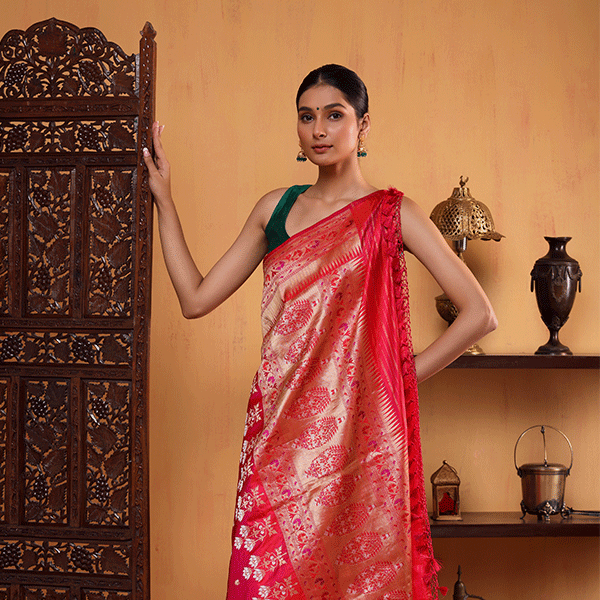 Close-up view of the exquisite four-sided handwoven Paithani border and shimmering gold threads on the deep royal magenta Katan silk saree.