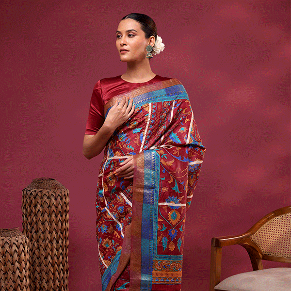Close-up view of the detailed traditional Kantha embroidery work on the vibrant maroon Tussar silk fabric, showcasing the artisan craftsmanship.