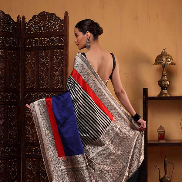 Close-up detail of the heavy weave gold zari accents and intricate striped pattern on the premium Midnight Majesty satin silk fabric.