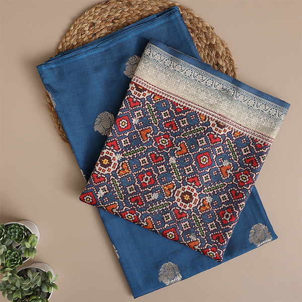 Close-up detail of the intricate traditional weaving and geometric motifs on the deep azure Banarasi Patola Silk fabric.