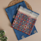 Close-up detail of the intricate traditional weaving and geometric motifs on the deep azure Banarasi Patola Silk fabric.