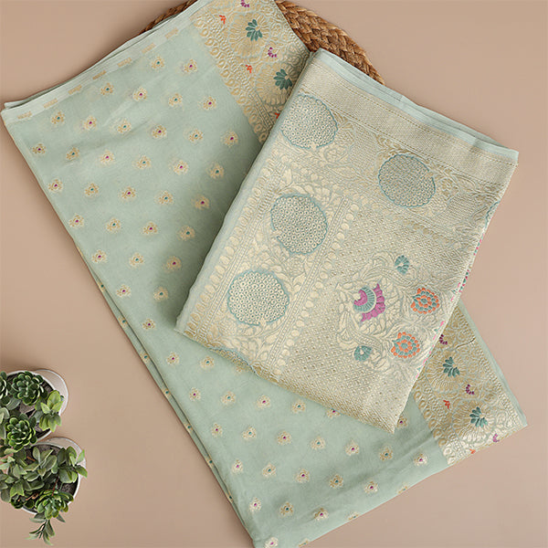 Close-up view of the premium mint green pure Georgette Silk fabric showcasing the detailed traditional handloom weave structure and delicate Meena and Resham embroidery.