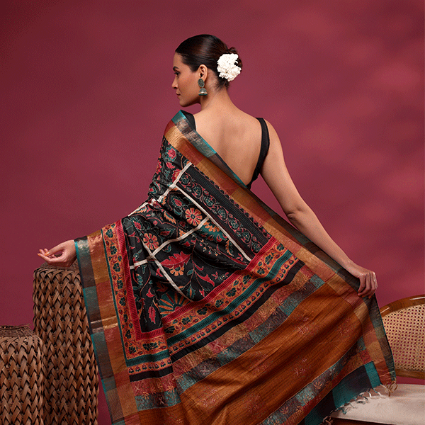 Close-up view of the detailed traditional multi-colored Kantha embroidery and floral artwork on the Tussar silk saree pallu.