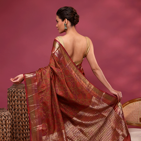 Back view of a model showcasing the elegant gold zari pallu and matching gold blouse of the Mystic Elysium China silk saree.