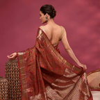 Back view of a model showcasing the elegant gold zari pallu and matching gold blouse of the Mystic Elysium China silk saree.