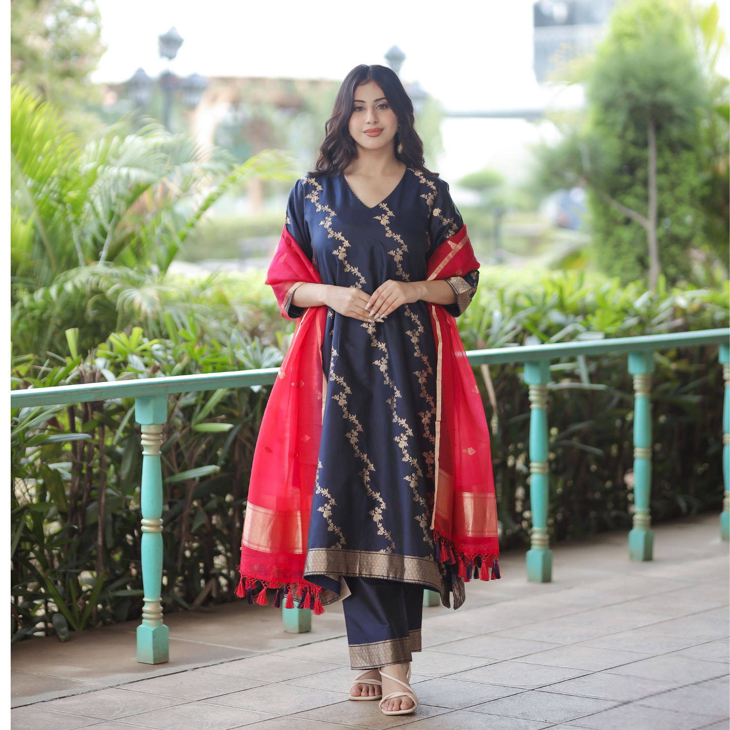 Full-length view of a Navy Blue Handwoven Banarasi Silk Suit featuring gold zari work, 3/4 sleeves, and a contrast Red Kora Silk Dupatta.