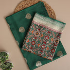 Close-up shot of the premium ocean mist green pure Patola Silk dress material, showcasing the detailed traditional Banarasi handloom weave structure and elegant metallic motifs.