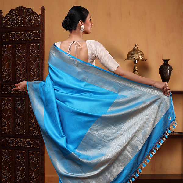 Elegant drape view of the oceanic azure tissue silk saree showcasing its graceful fall and shimmering gold and silver zari accents.