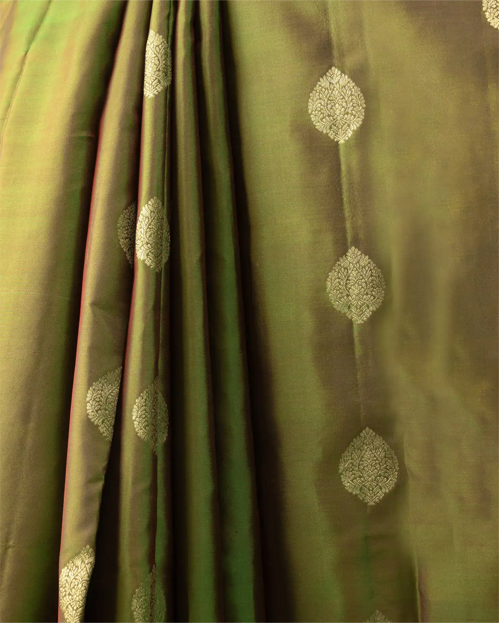 A styled look featuring the olive green Kanjivaram silk saree paired with traditional temple jewelry.