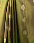 A styled look featuring the olive green Kanjivaram silk saree paired with traditional temple jewelry.