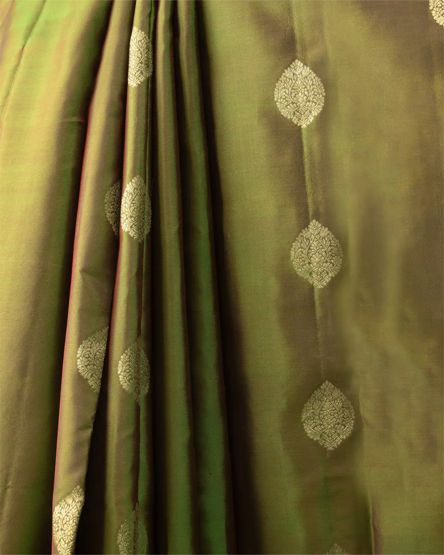 A styled look featuring the olive green Kanjivaram silk saree paired with traditional temple jewelry.