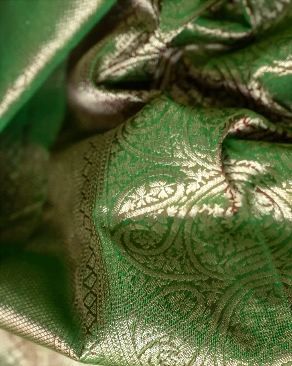 Full-length view of the olive green Kanjivaram silk saree showcasing its graceful drape and silhouette. 