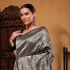 Close-up view of the heavy, regal golden zari pallu on the handwoven brocade Banarasi silk saree.